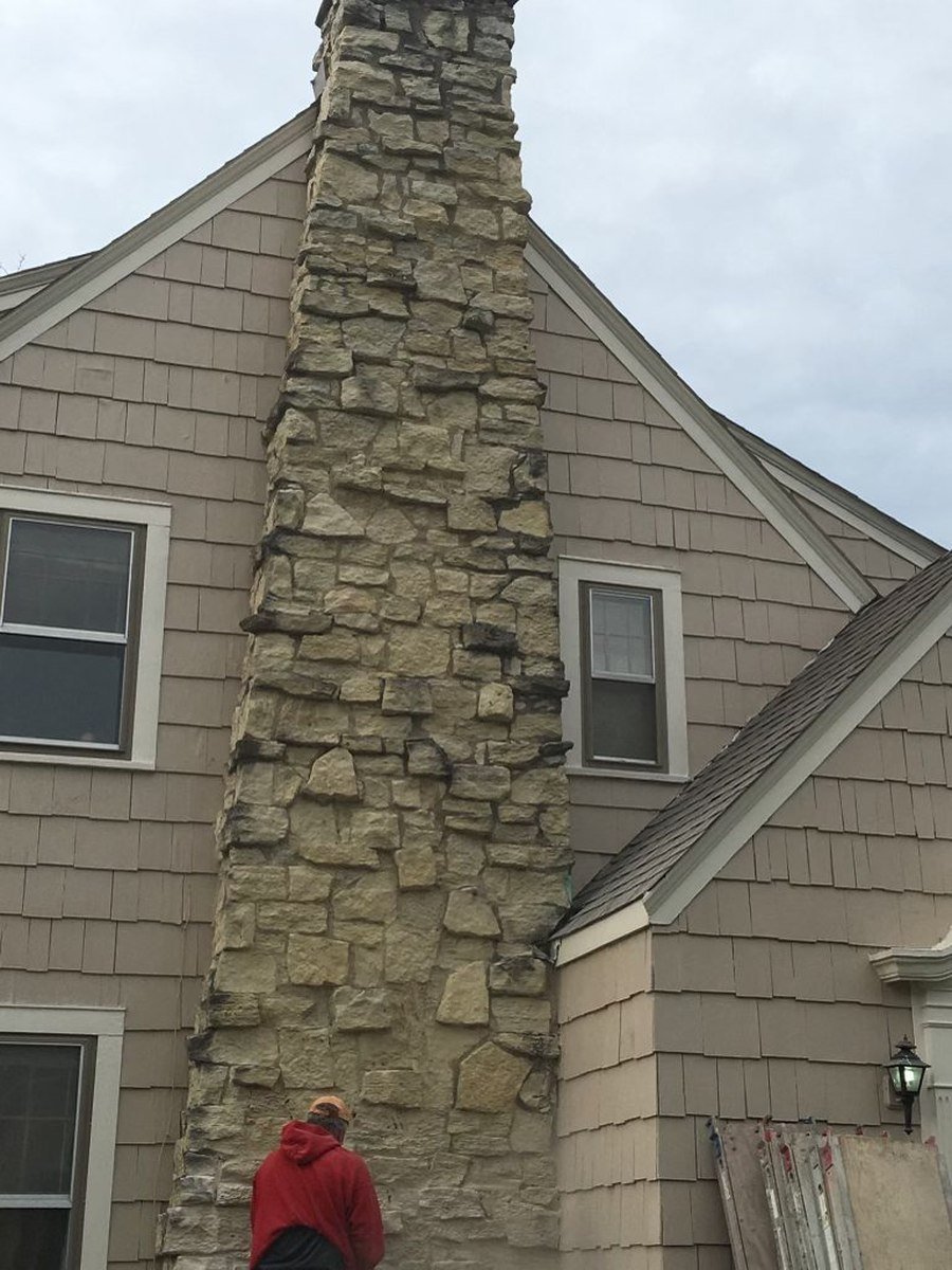 Stone chimney before repointing, weathered mortar joints