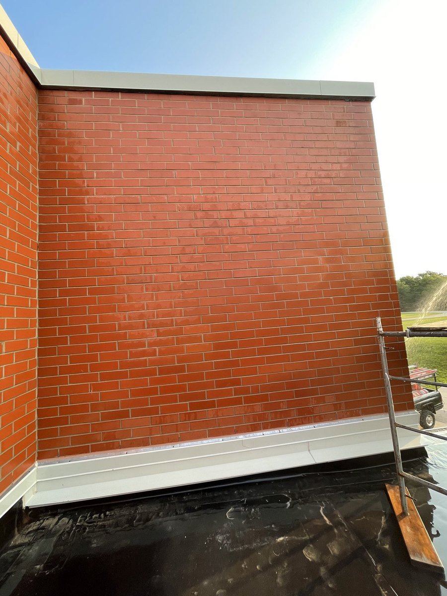 Masonry wall sealed and waterproofed at the roof junction